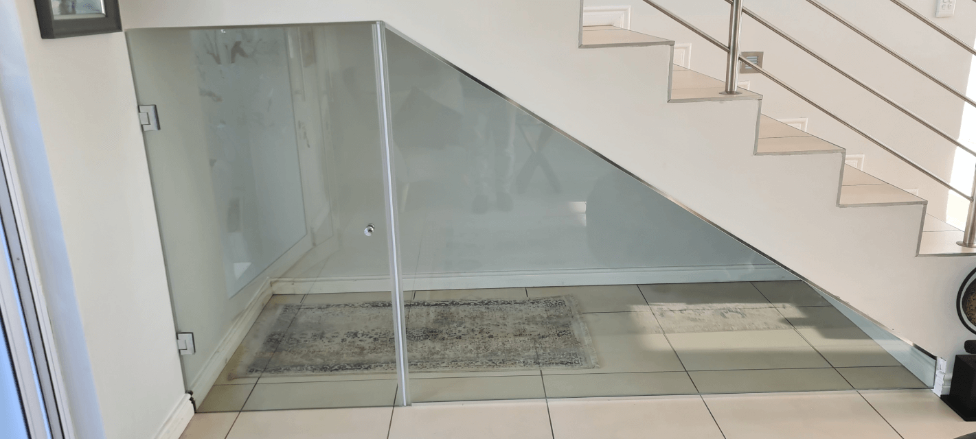 Wine cellar under staircase with glass accents