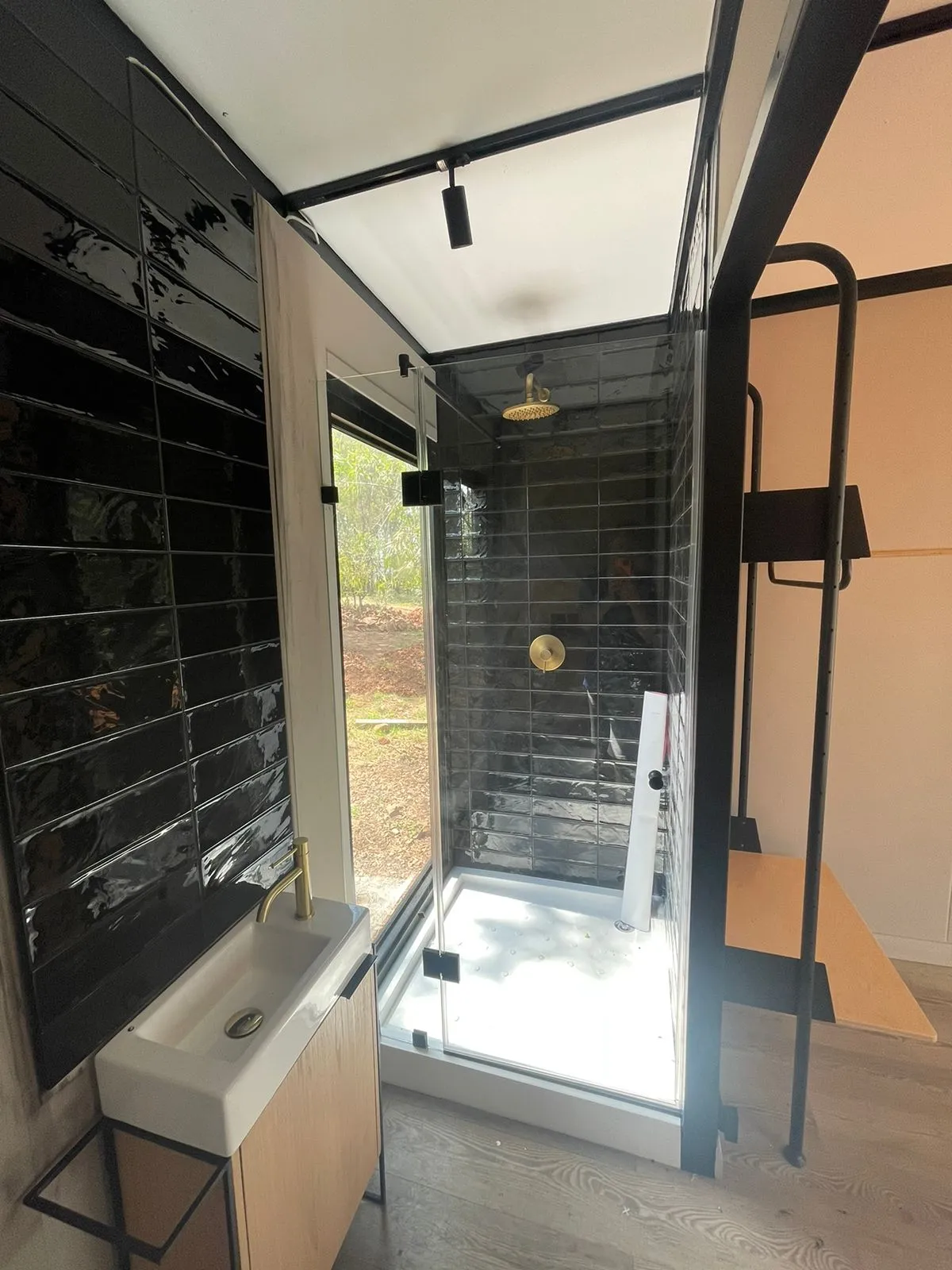 Shower with glass window offering outdoor view - alufox
